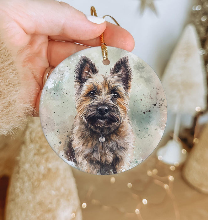 a hand holding a glass ornament with a picture of a dog