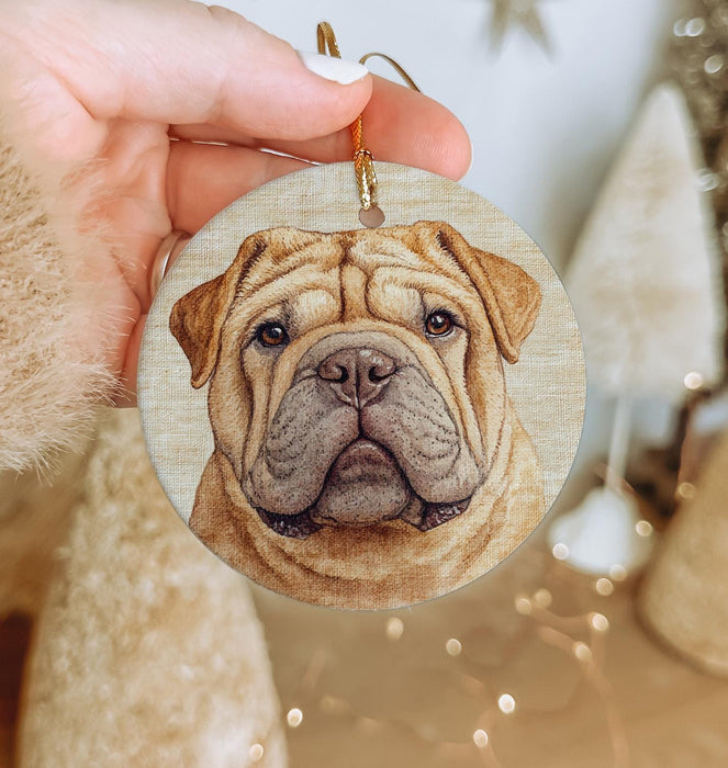 a person holding a dog ornament in their hand