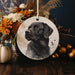 a black dog ornament hanging on a table