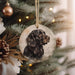 a black dog ornament hanging from a christmas tree