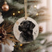 a black dog ornament hanging from a christmas tree