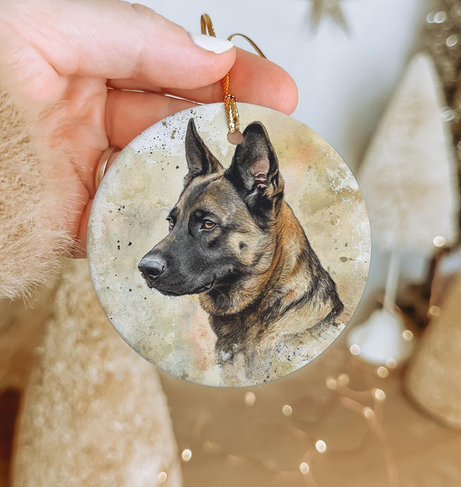 a hand holding a christmas ornament with a german shepherd picture on it