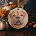 a wooden ornament with a picture of a dog on it