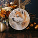 a ceramic ornament with a picture of a fox on it