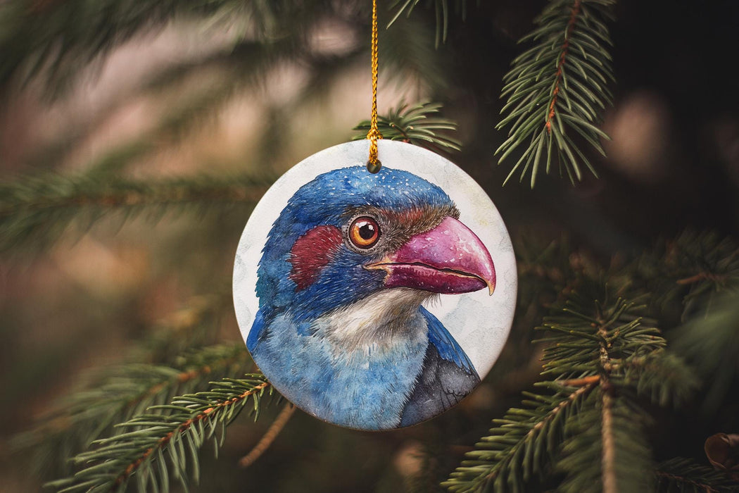 a blue bird ornament hanging from a tree