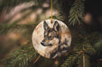 a wolf ornament hanging from a christmas tree