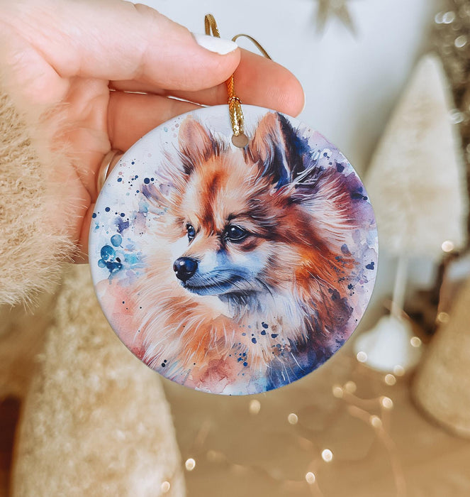 a person holding a dog ornament in their hand