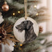 a black dog ornament hanging from a christmas tree