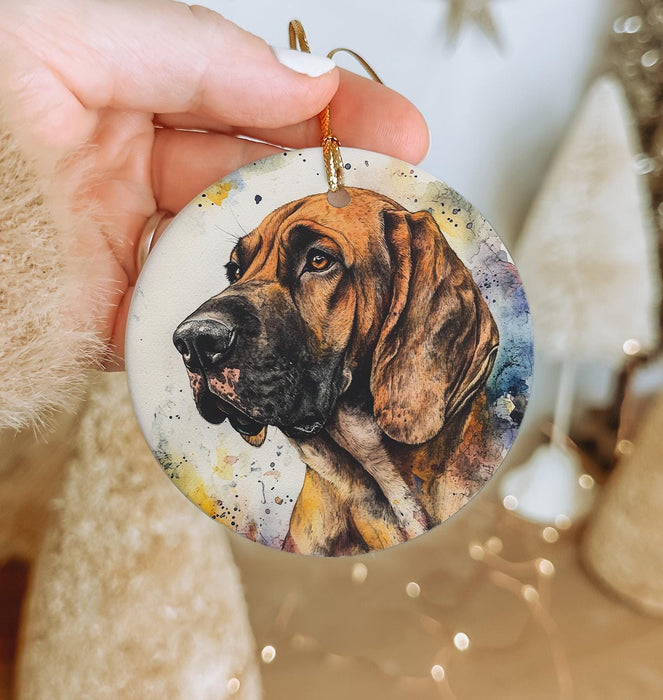 a hand holding a christmas ornament with a picture of a dog