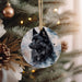 a black dog ornament hanging from a christmas tree