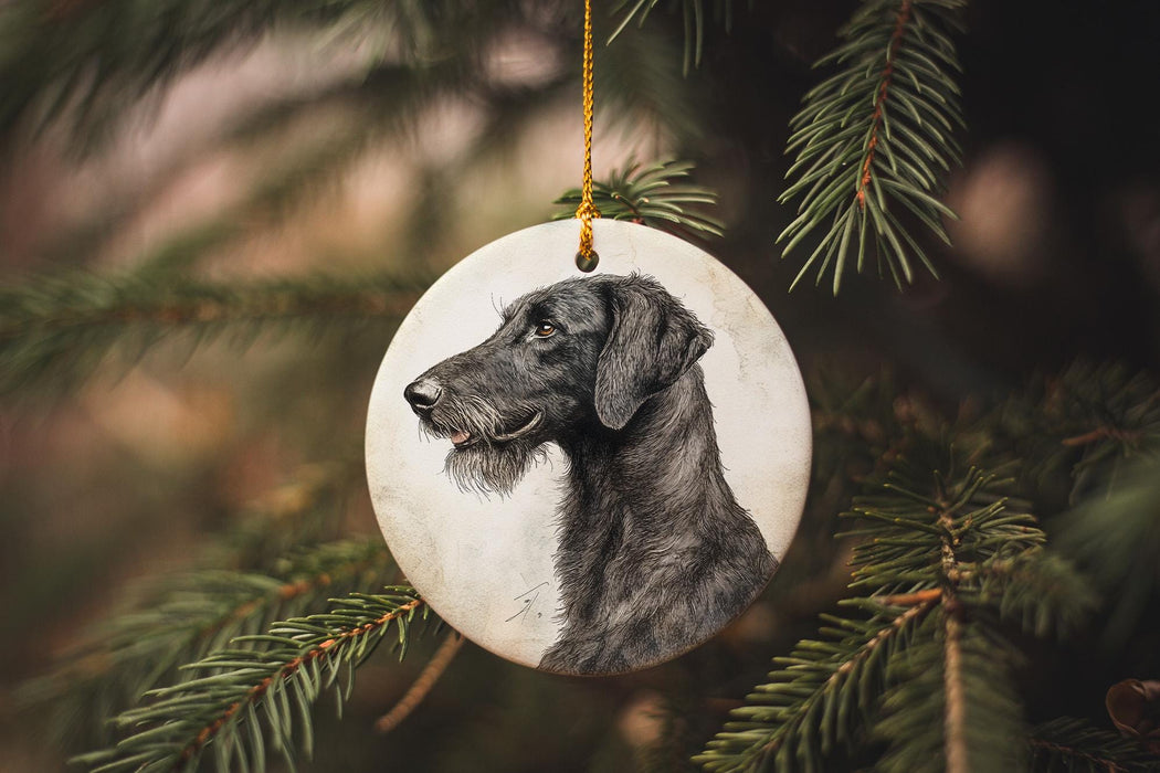 a black dog ornament hanging from a christmas tree