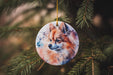 a ceramic ornament with a picture of a fox on it