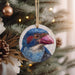 a blue bird ornament hanging from a christmas tree