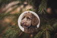 a dog ornament hanging from a christmas tree