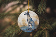 a ceramic ornament hanging from a christmas tree