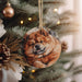 a dog ornament hanging from a christmas tree