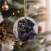 a black dog ornament hanging from a christmas tree