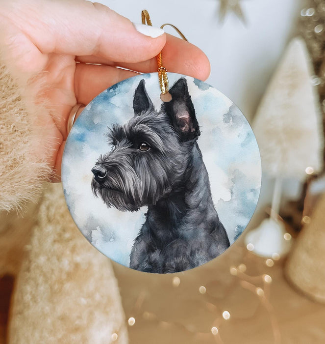 a hand holding a round ornament with a picture of a dog