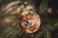 a dog ornament hanging from a christmas tree