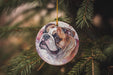 a ceramic ornament hanging from a christmas tree