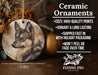 a ceramic ornament with a picture of a wolf