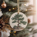 a ceramic ornament hanging from a christmas tree