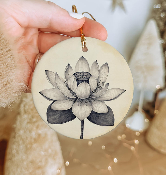a person holding a ceramic ornament with a flower on it
