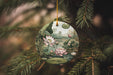 a ceramic ornament hanging from a pine tree