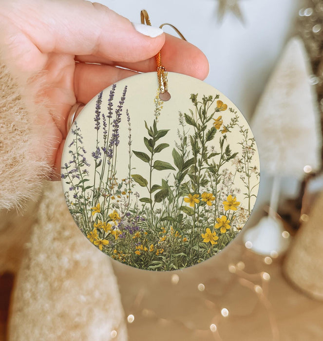 a person holding a round ornament with flowers on it