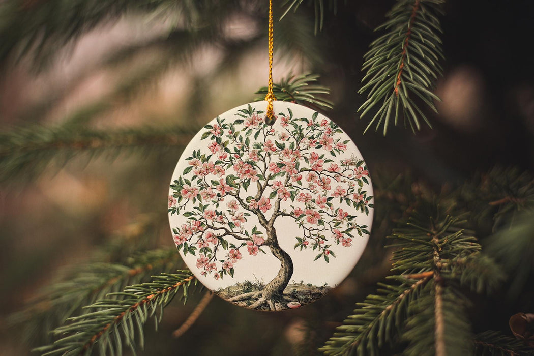 a ceramic ornament hanging from a christmas tree