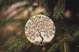 a ceramic ornament hanging from a christmas tree