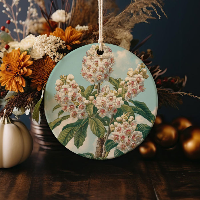 a ceramic ornament with flowers and leaves on a table