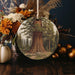a ceramic ornament with a picture of a tree on it