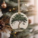 a ceramic ornament hanging from a christmas tree