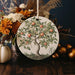a ceramic ornament with an apple tree painted on it