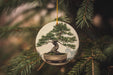 a ceramic ornament with a bonsai tree on it