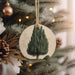 a christmas ornament hanging from a christmas tree