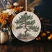 a ceramic ornament with a tree on it
