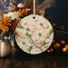 a ceramic ornament decorated with flowers and leaves