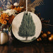 a ceramic ornament with a picture of a tree on it