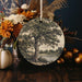a ceramic ornament with a tree on it