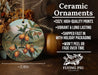 a ceramic ornament with a painting of oranges on it