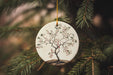 a ceramic ornament hanging from a christmas tree