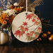 a ceramic ornament decorated with autumn leaves