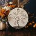 a ceramic ornament with a tree painted on it
