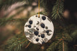a ceramic ornament hanging from a pine tree