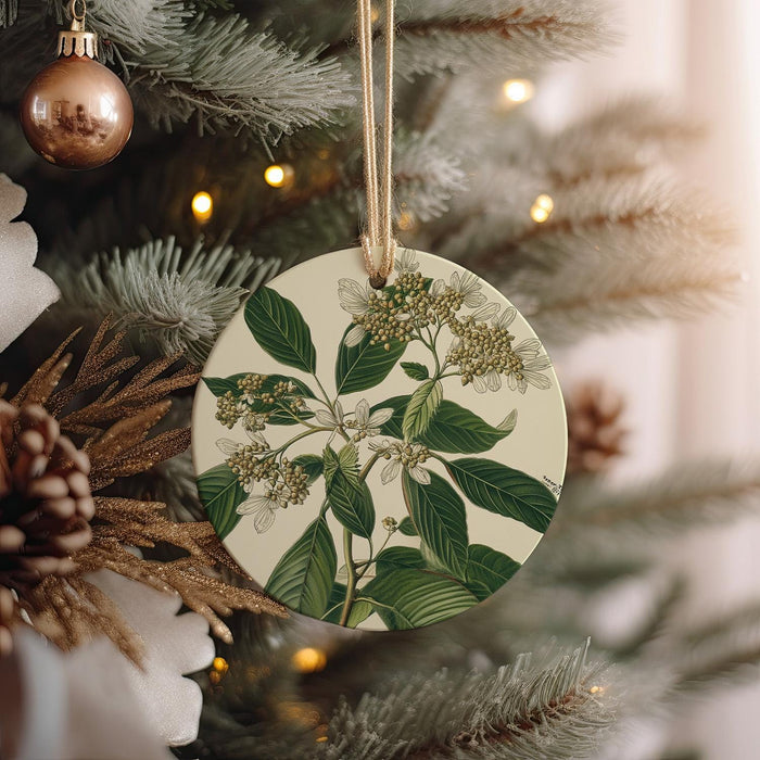 a ceramic ornament hanging from a christmas tree