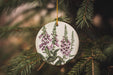 a ceramic ornament hanging from a christmas tree