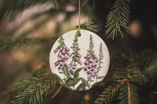 a ceramic ornament hanging from a christmas tree