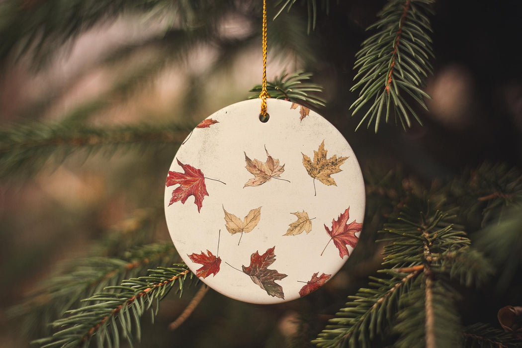 a ceramic ornament hanging from a christmas tree